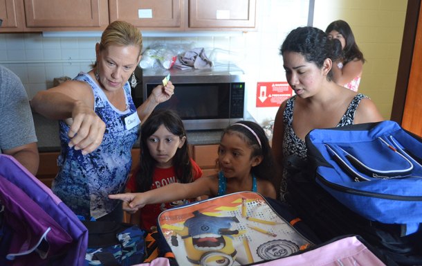 Operation Homefront Volunteer Cheryl Bass with parent Elena Maldonado and kids Esmeralda, Katherine and cousin Gisell.